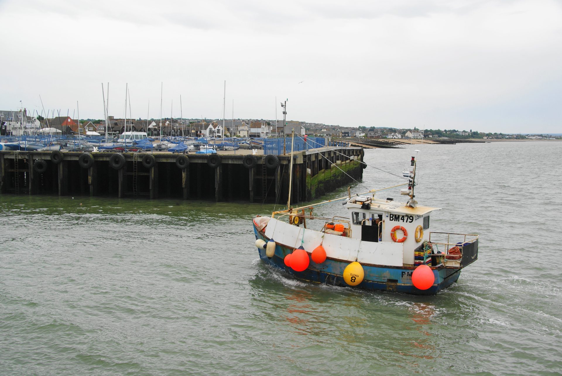 Working fishing boat returning to Whitstable Harbour